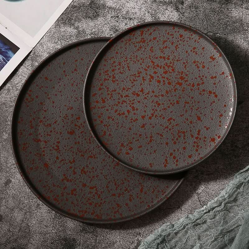 Rustic glazed Oxid Metal Look Ceramic Plates with splatter detail on textured surface.