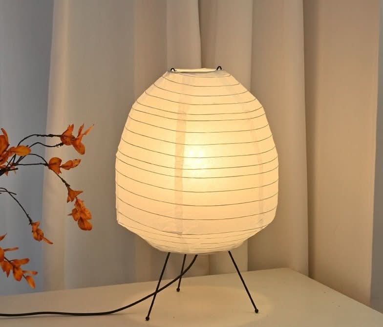 Paper Table Lamp, irregular polygon shape, on a white surface next to autumnal decor.