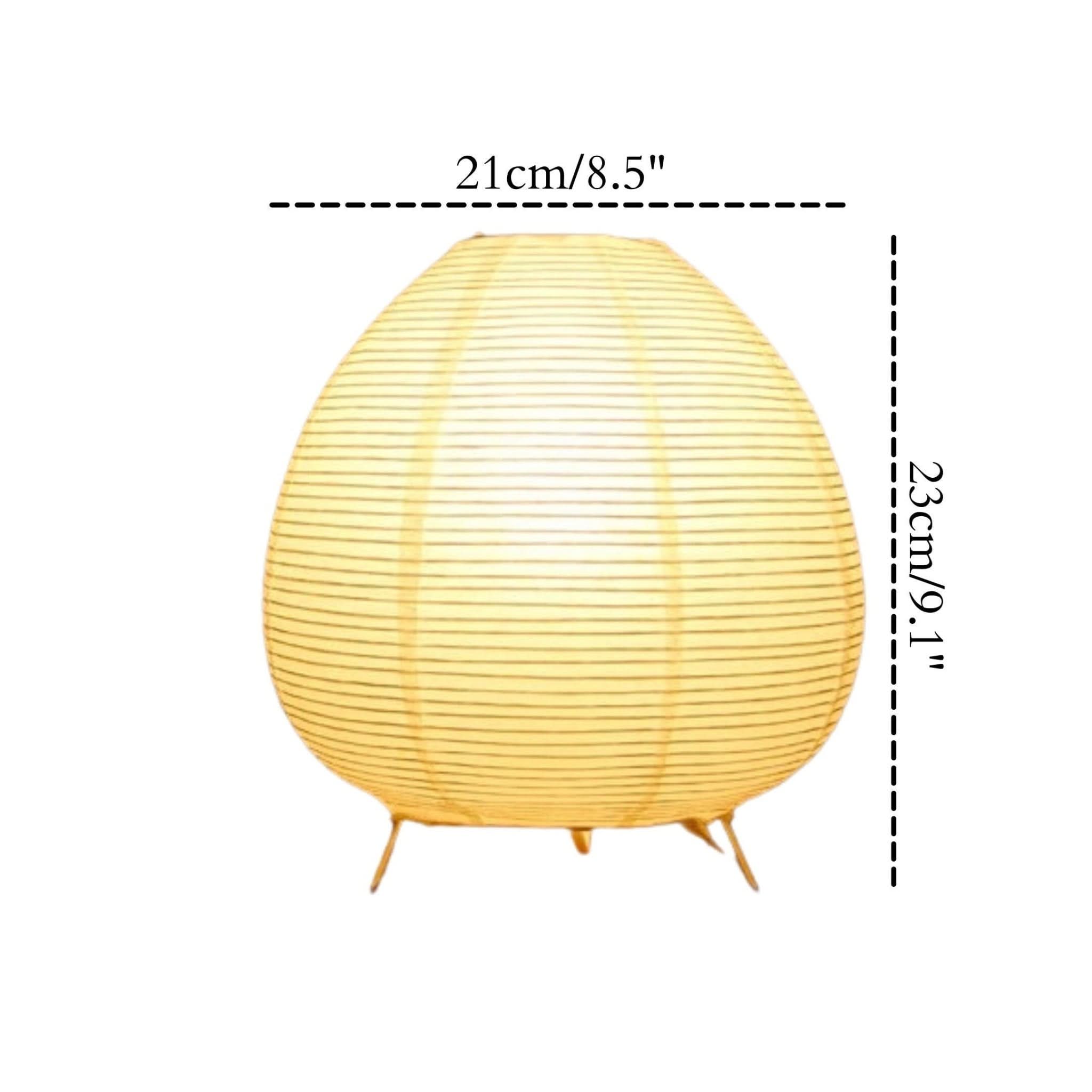 Yellow striped paper table lamp with delicate legs, a soft glow.