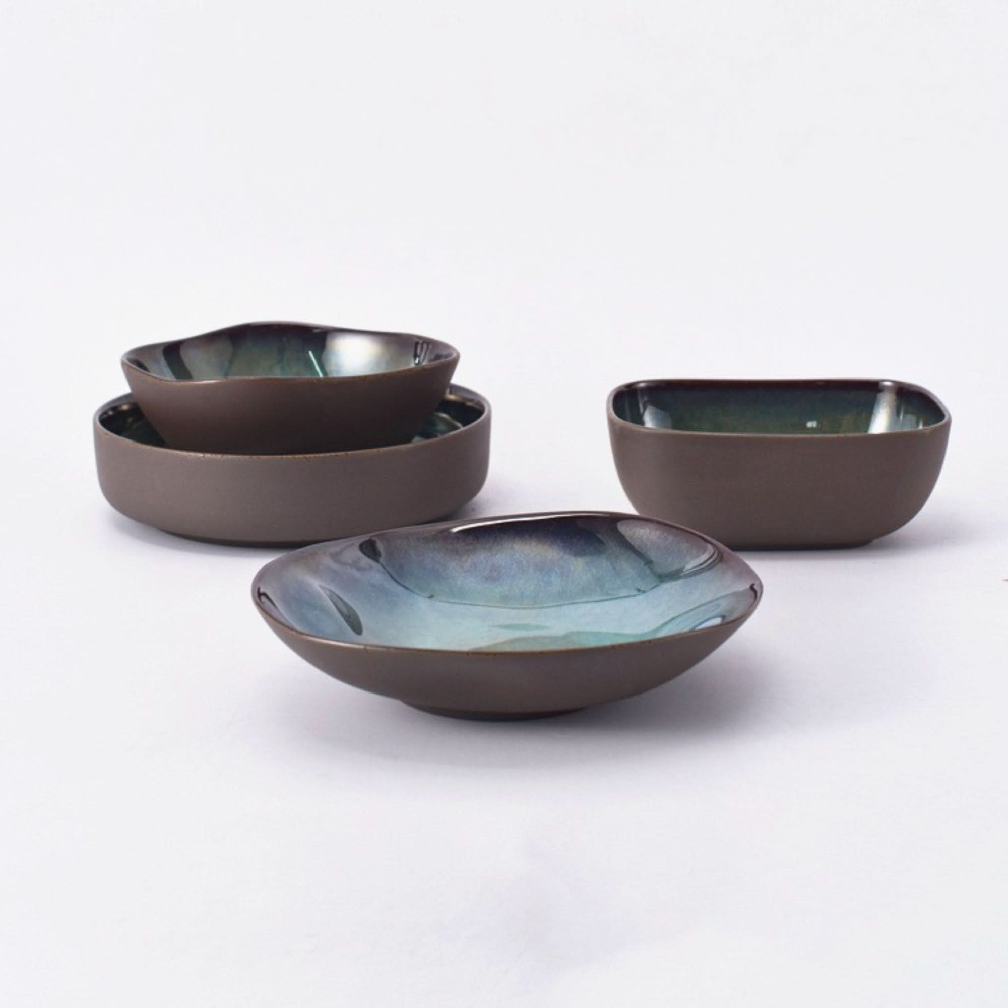 Gray matt stoneware pasta bowls with iridescent glazed interiors, rustic Japanese style.