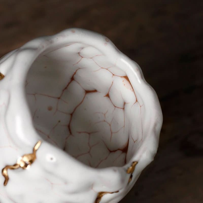White & gold glazed Kintsugi tea cup, handmade in Japan. Unique Kintsugi pattern inside.