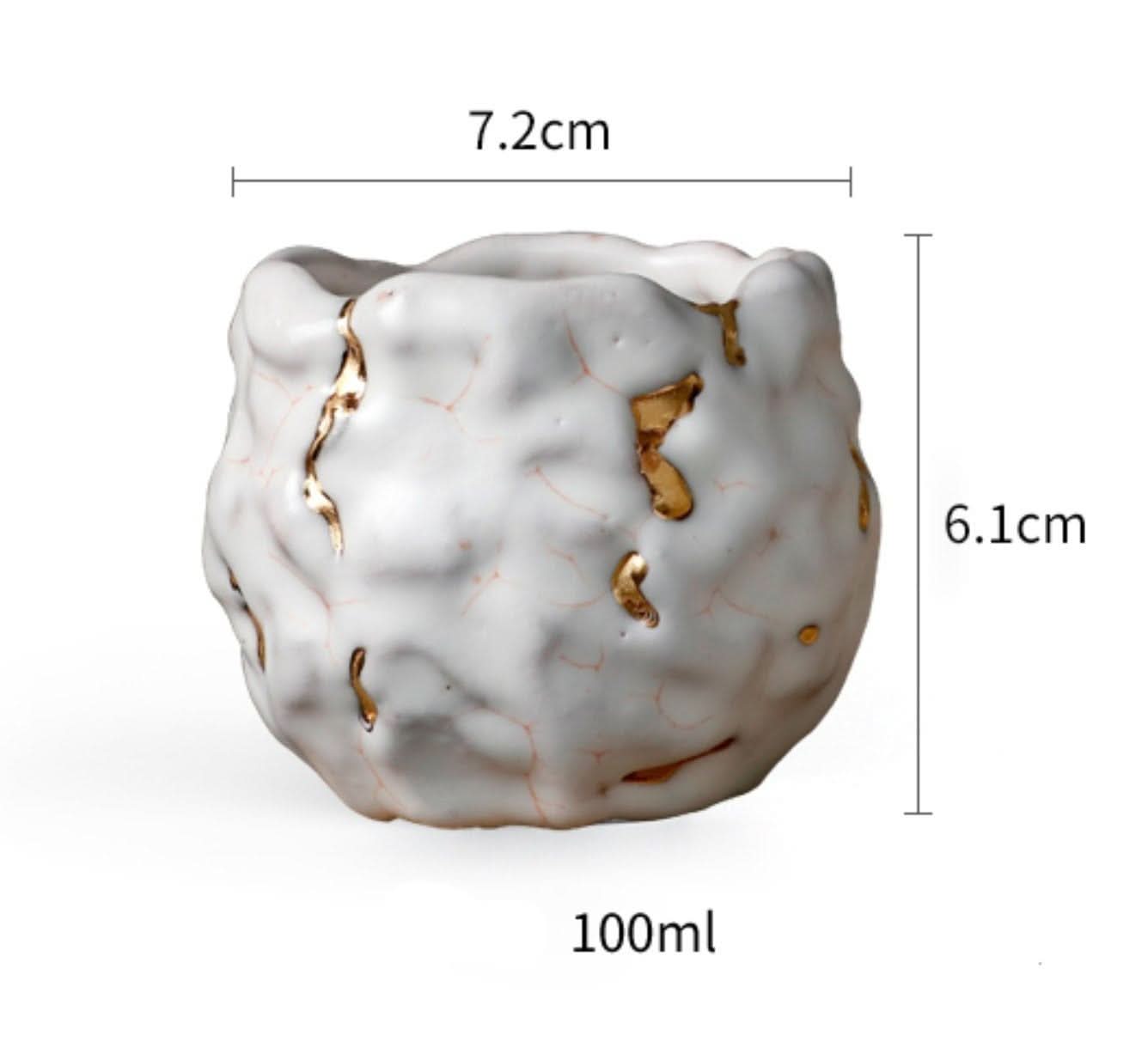 White and gold glazed porcelain tea cup, Kintsugi style, handmade in Japan.