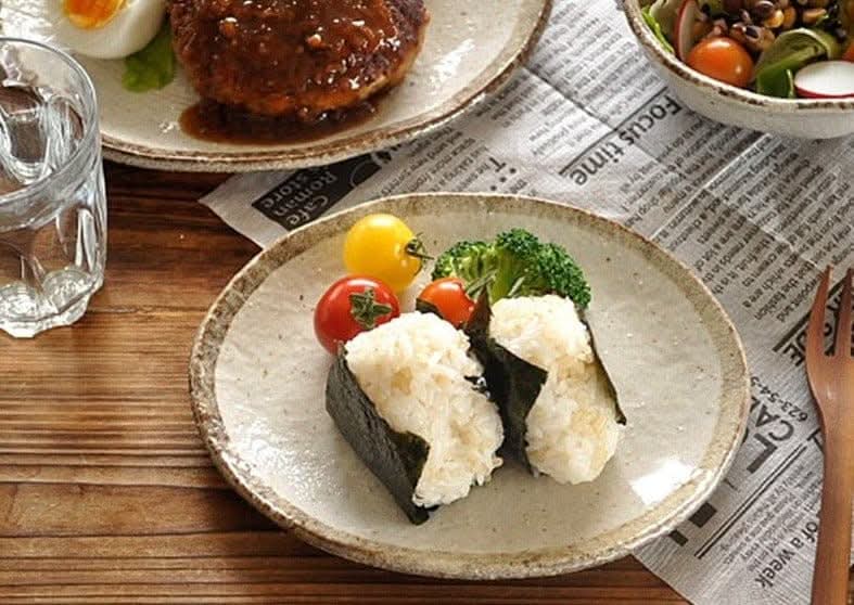 Rough Pottery Stoneware Dinner Set with rice balls, tomatoes & broccoli on a wooden table.