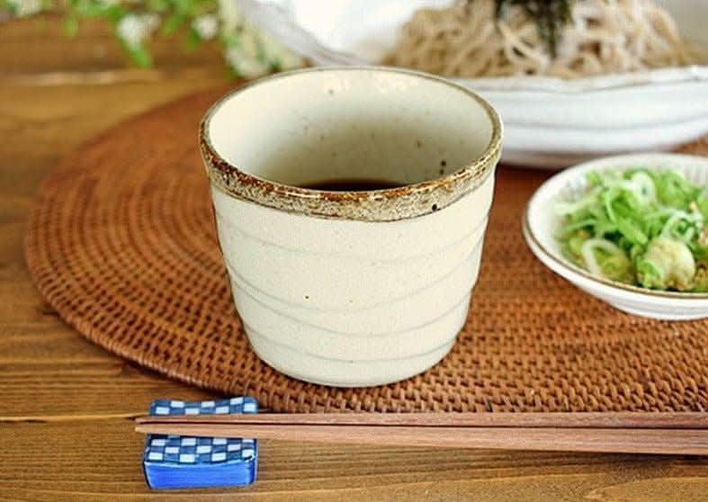 Cream stoneware cup from the Rough Pottery Stoneware Dinner Set with Japanese meal setting.