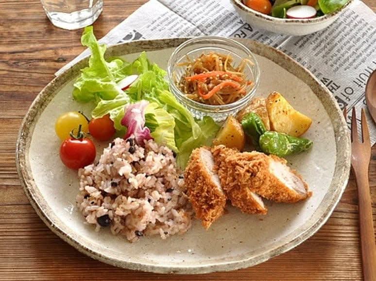 Rough Pottery Stoneware Dinner Set: Meal with salad, rice, chicken, and potatoes on a textured ceramic plate.