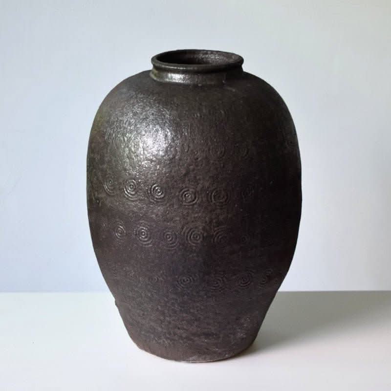 Rustic Distressed Rounded Vase with black shiny texture & circular engraved pattern.
