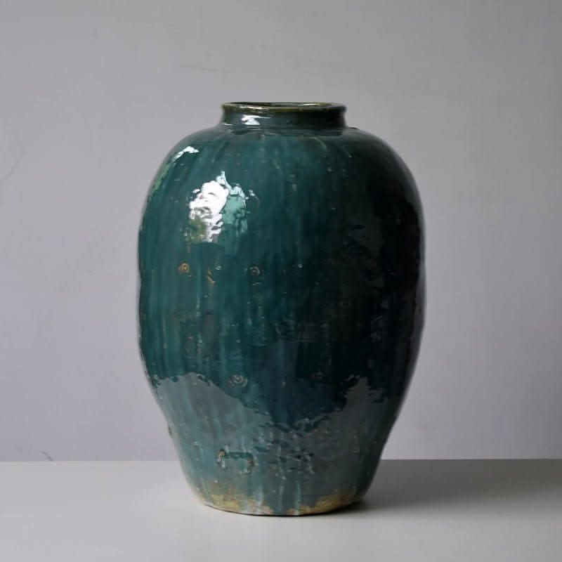 Rustic Distressed Rounded Vase with dark green blue glaze and circular engraved pattern.