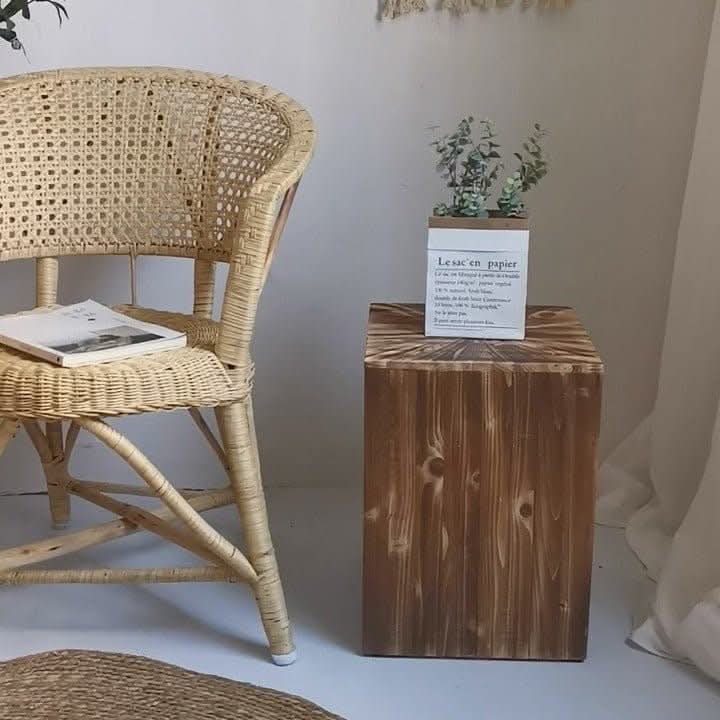 Rustic Geometric Board Stool Customized: Natural wood cube stool with plant and book on rattan chair.