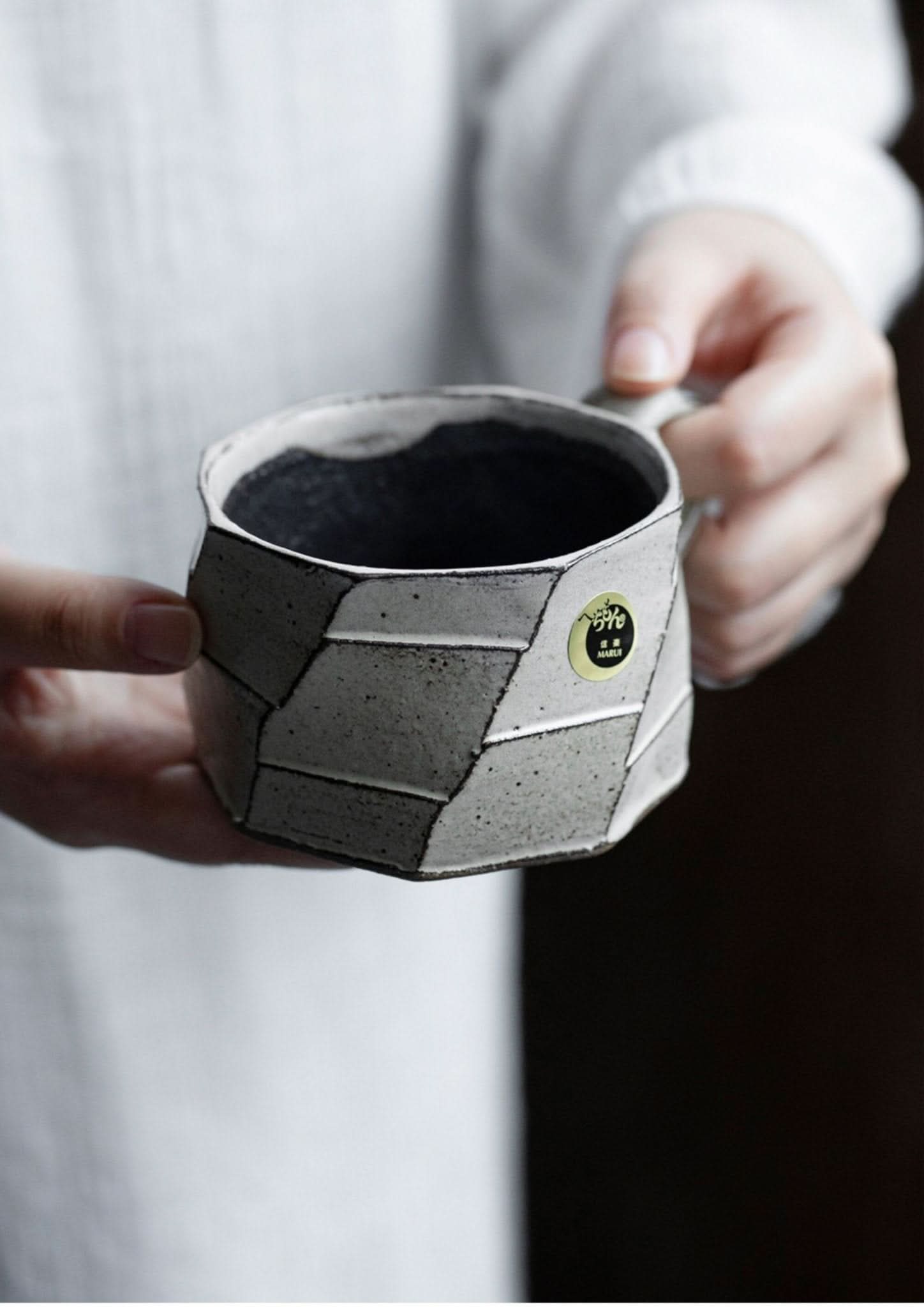 Rustic hand-made carved white stoneware mug from Japan. Ceramic, glazed, hand-thrown pottery.