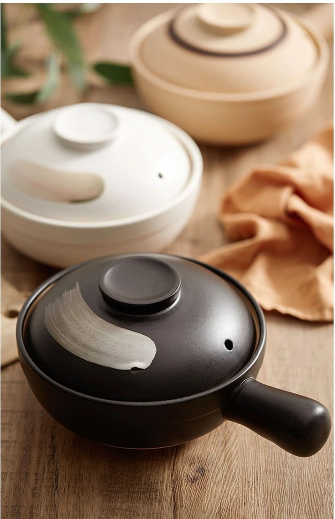 Rustic Unglazed Stoneware Baking Plates: black & white ceramic pots on wooden table