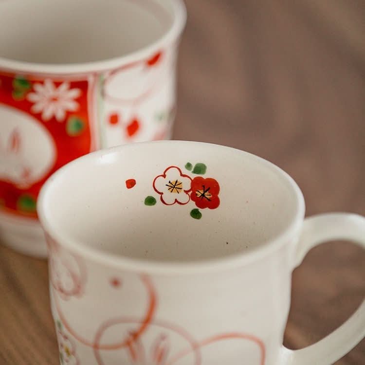 Hand-painted Sakura Rabbit Couple Mug Set with floral detail.