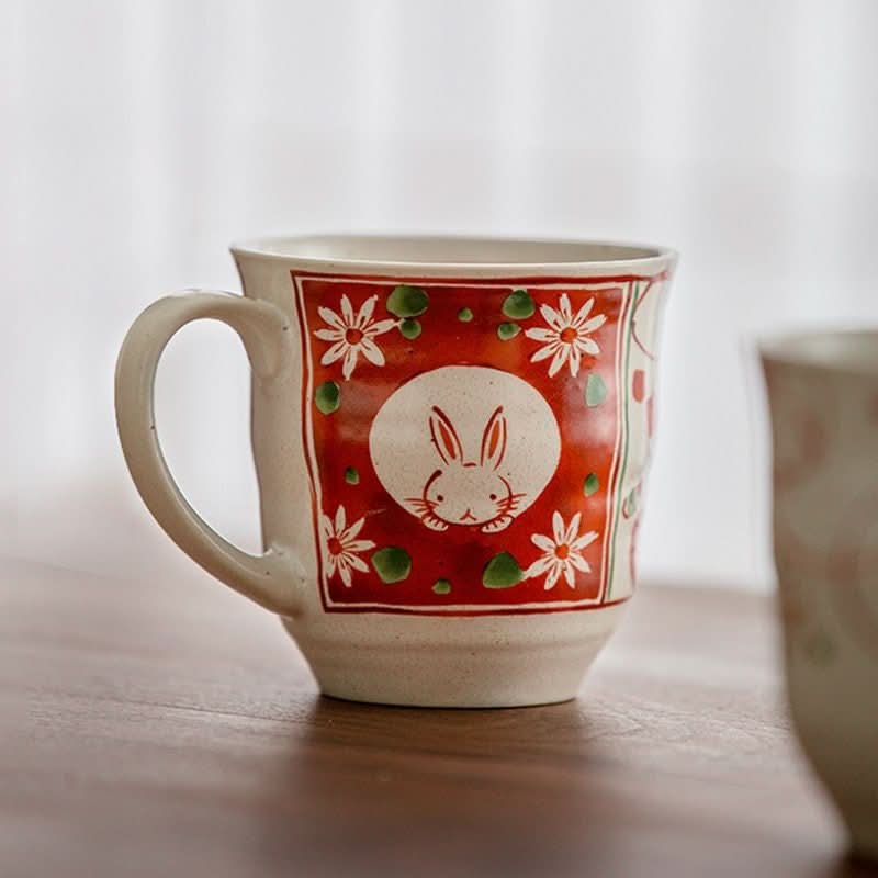 Sakura Rabbit Couple Mug: hand-painted ceramic mug with red floral design and bunny motif.