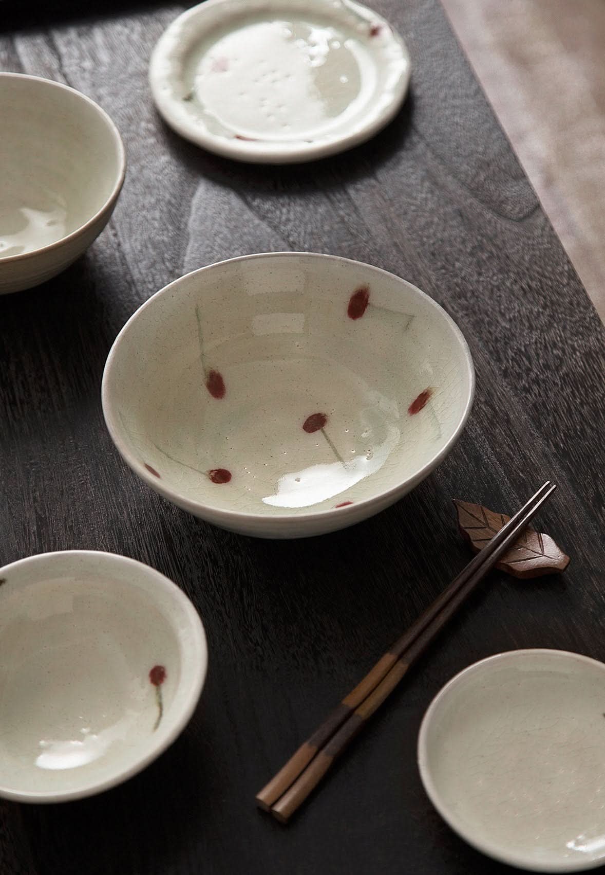 Ice Cracked Cherry Glaze Tableware Set: rustic, hand-made Japanese dinnerware with red cherry accents on dark wood.