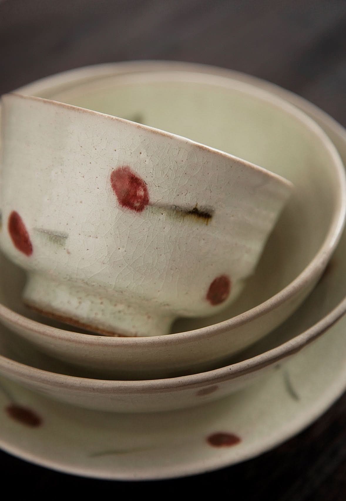 Set of Ice Cracked Cherry Glaze Tableware Set with red speckles and a rustic, handmade Japanese aesthetic.