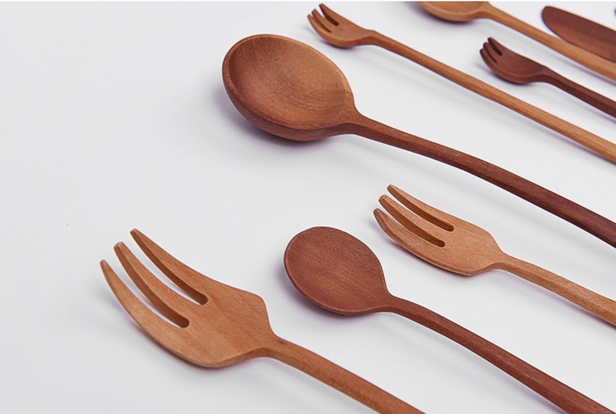 Set of Japan 12 Wooden Kitchen Utensils: wood spoons & forks on white.