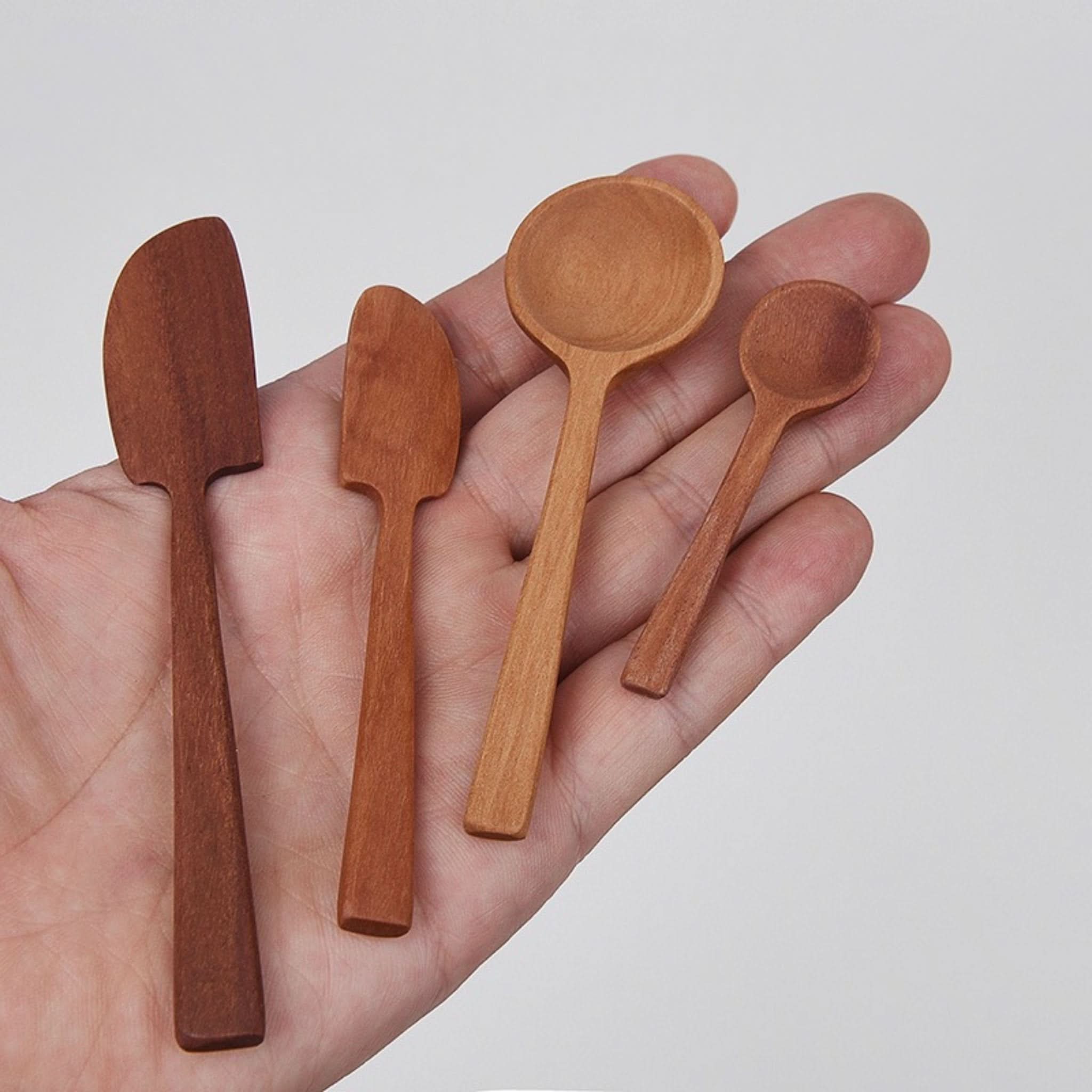 Set of Japan wooden kitchen utensils, tiny spoons & spreaders, held in palm.