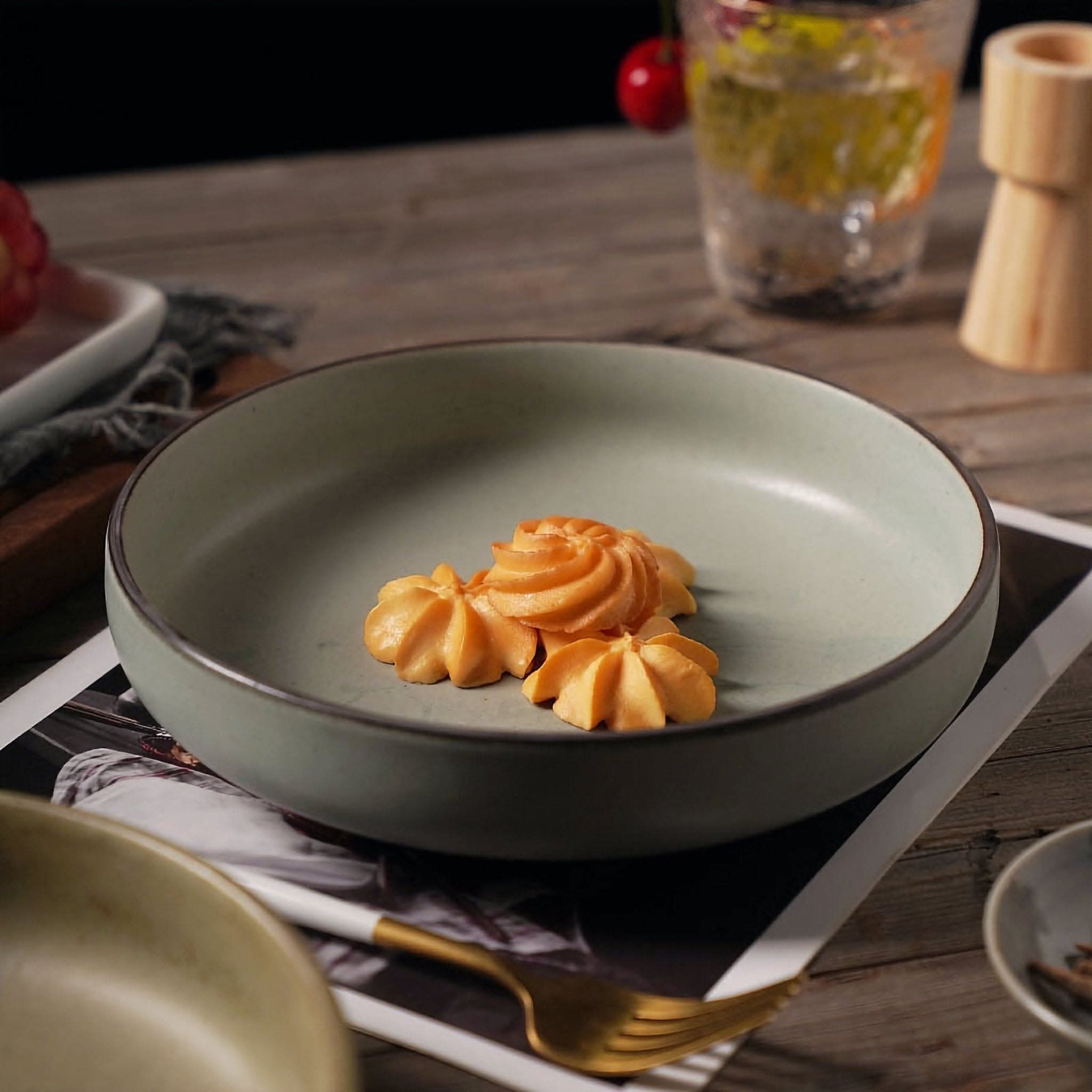Shallow plates with earthy colors | Ceramic dishes, salad bowl with cookies on rustic wood