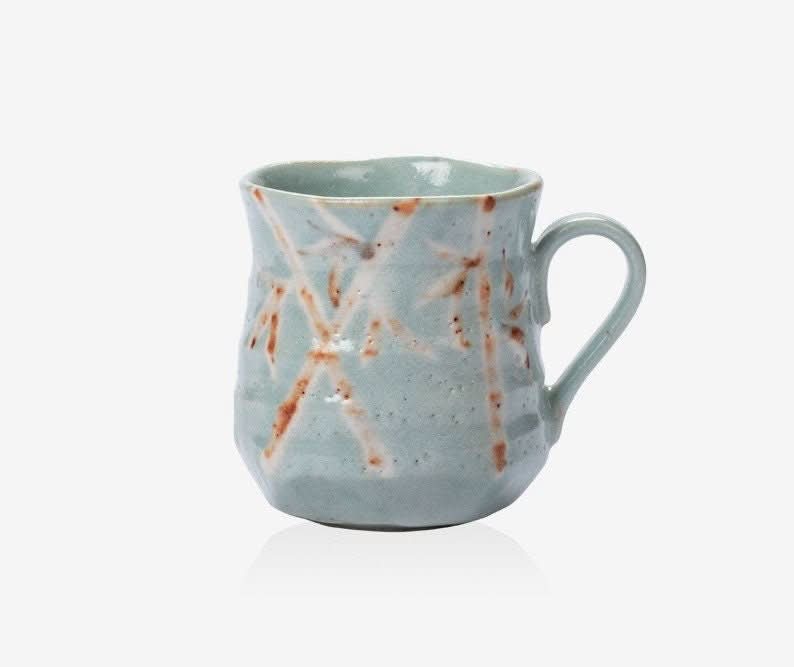 Shino-Yaki Spring mug: rustic pale blue ceramic with white and brown bamboo design.