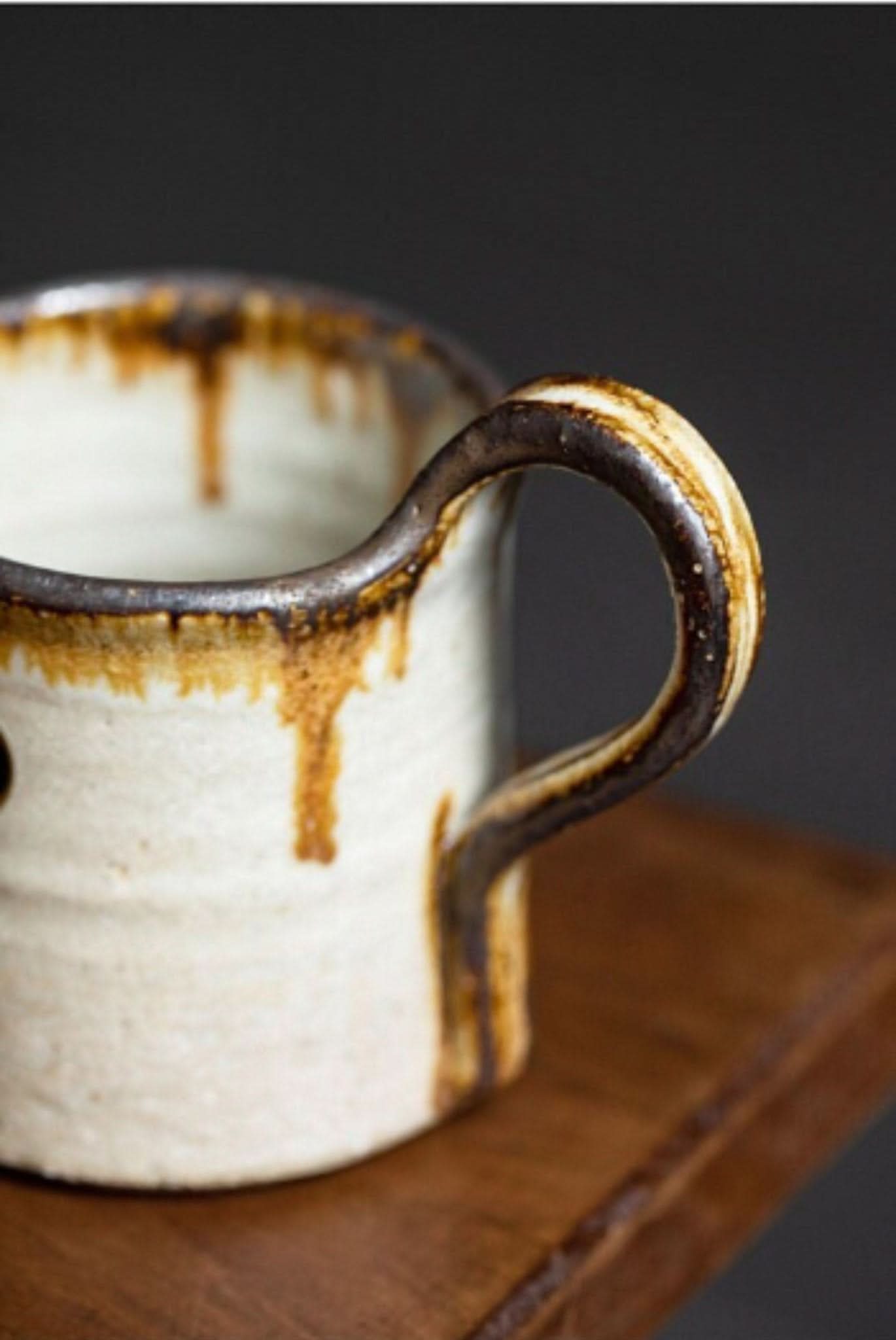 Rustic Shiraku-yaki stoneware mug, handmade in Japan, with a glazed, hand-thrown ceramic finish.