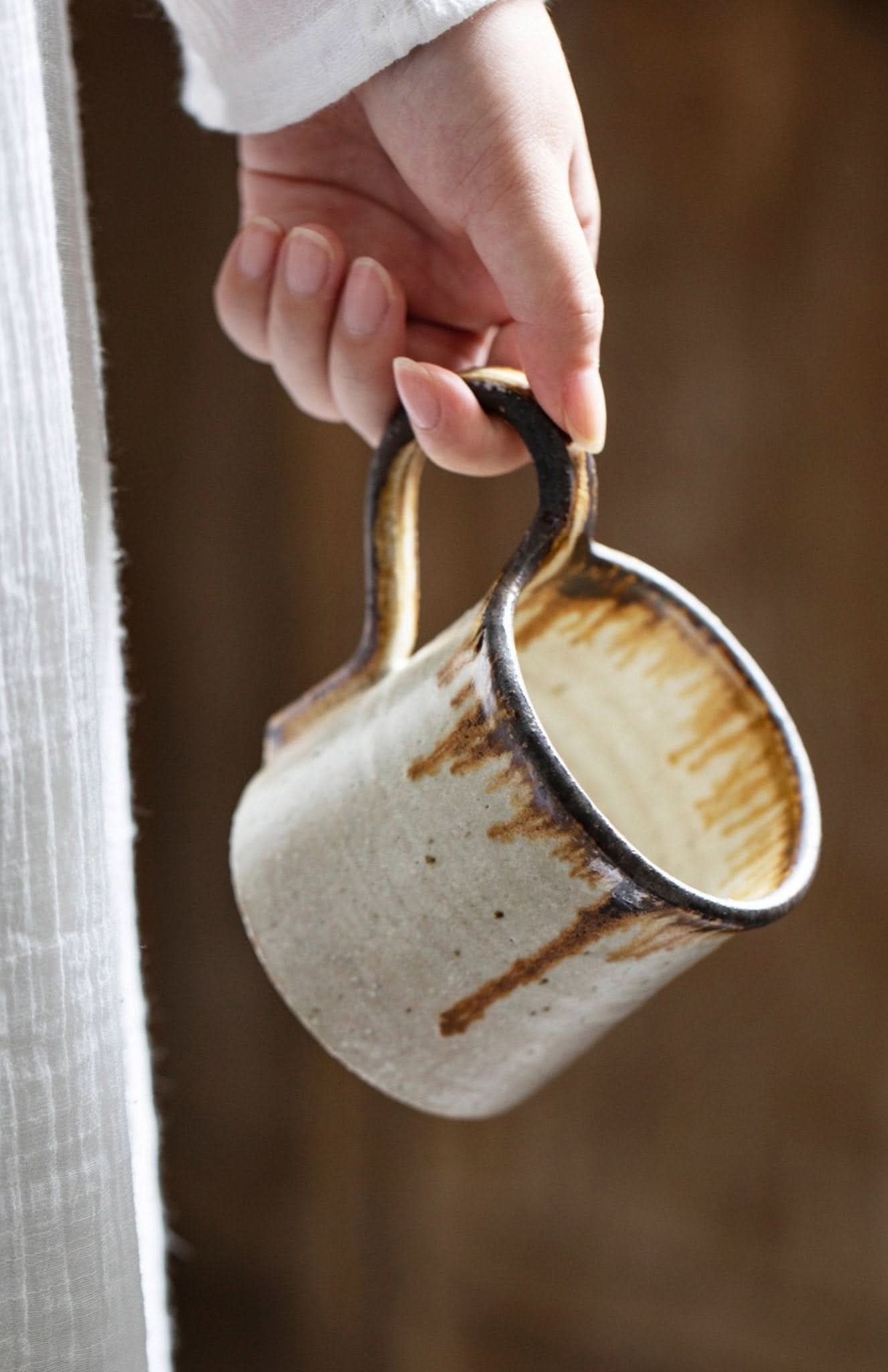Shiraku-yaki stoneware mug, handmade, glazed ceramic pottery in rustic tones.