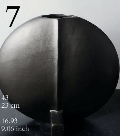 Small ceramic vase in black and gray with a modern, geometric design.