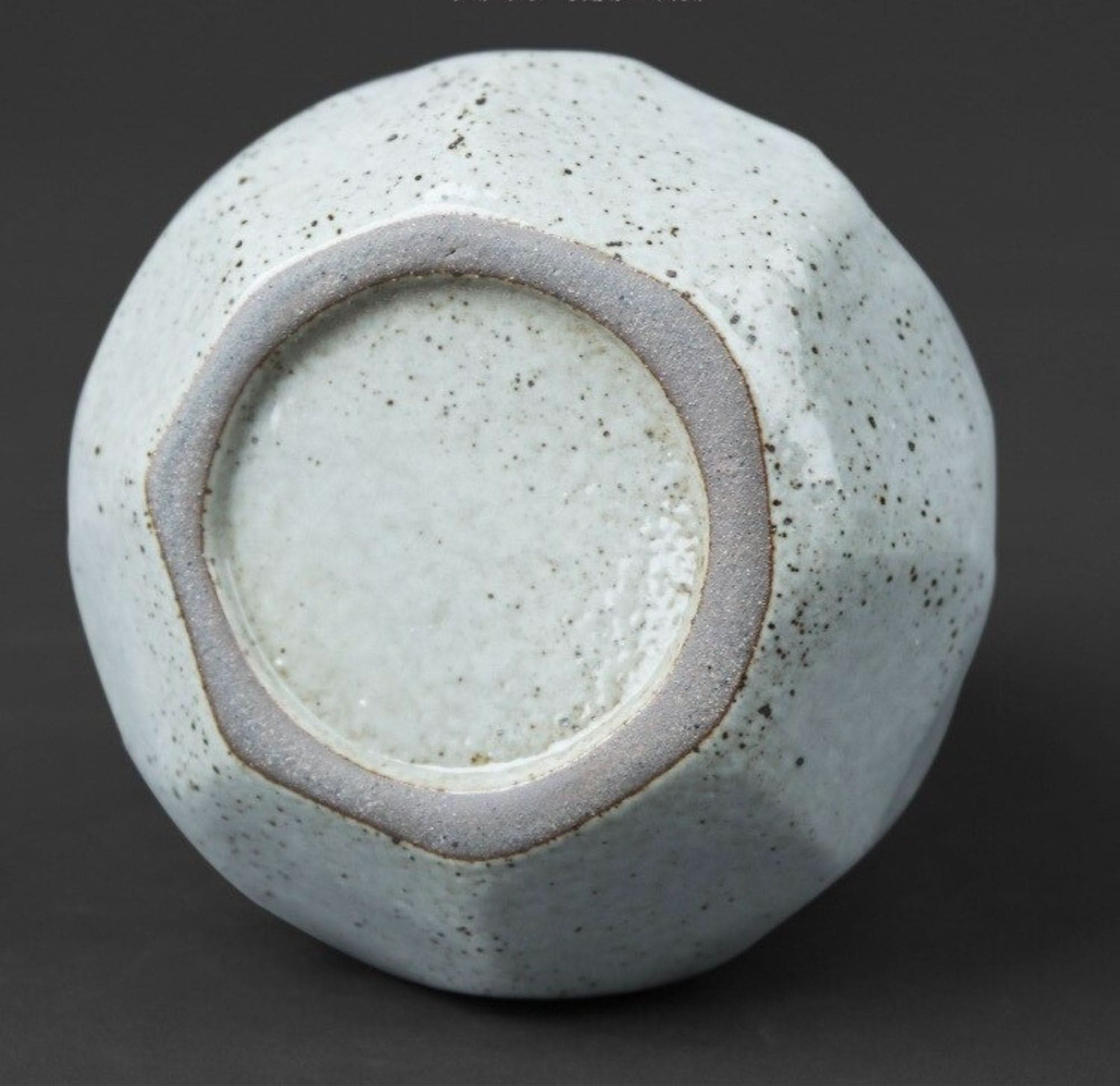 Light gray speckled stoneware sealed tea can with unglazed base ring.