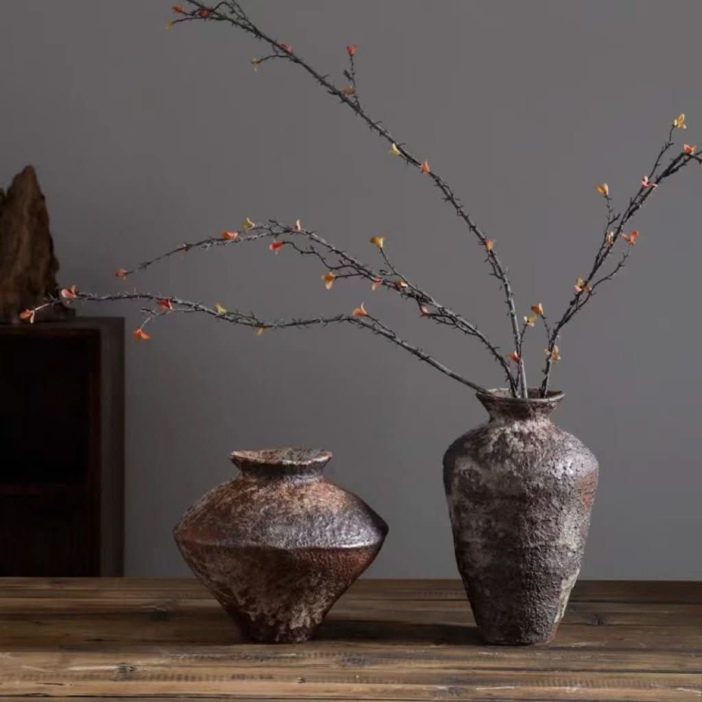 Two rustic Wabi Sabi ceramic vases with decorative branches, for home decor.