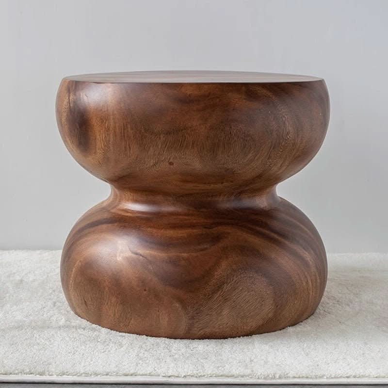 South American Walnut Solid Wood Stool, hourglass shape, natural wood grain texture on cream rug.