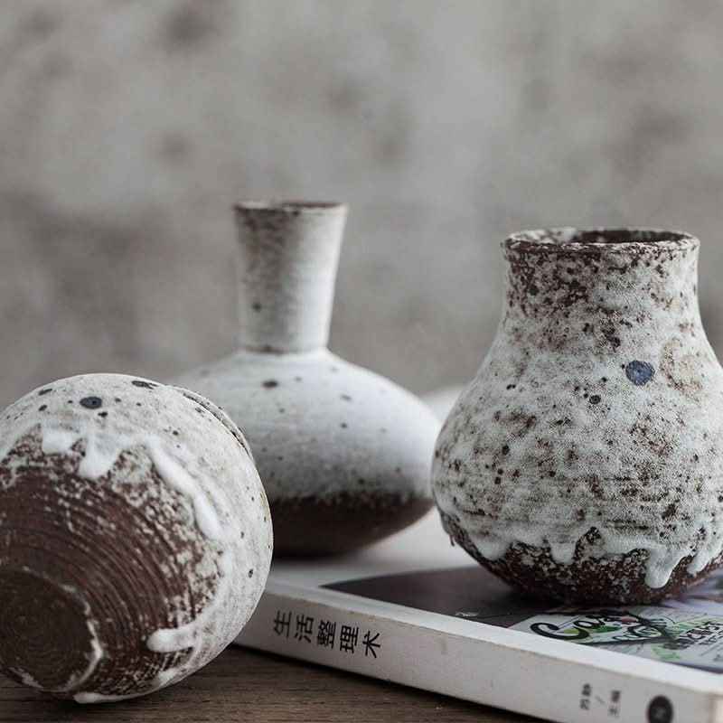 Speckled gray small ceramic vase with rustic stoneware texture.