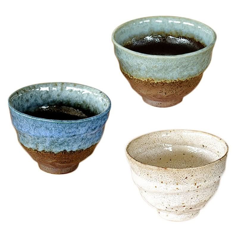 Three ceramic ramen bowls in blue, green, and speckled white.