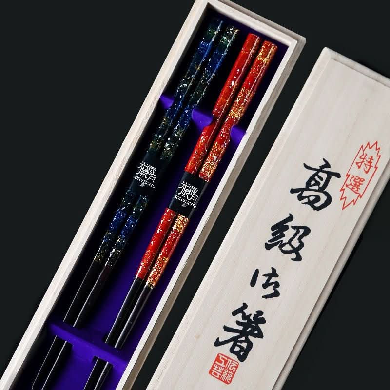 Handmade lacquered Japanese chopstick set, red & blue speckled, in wooden box.