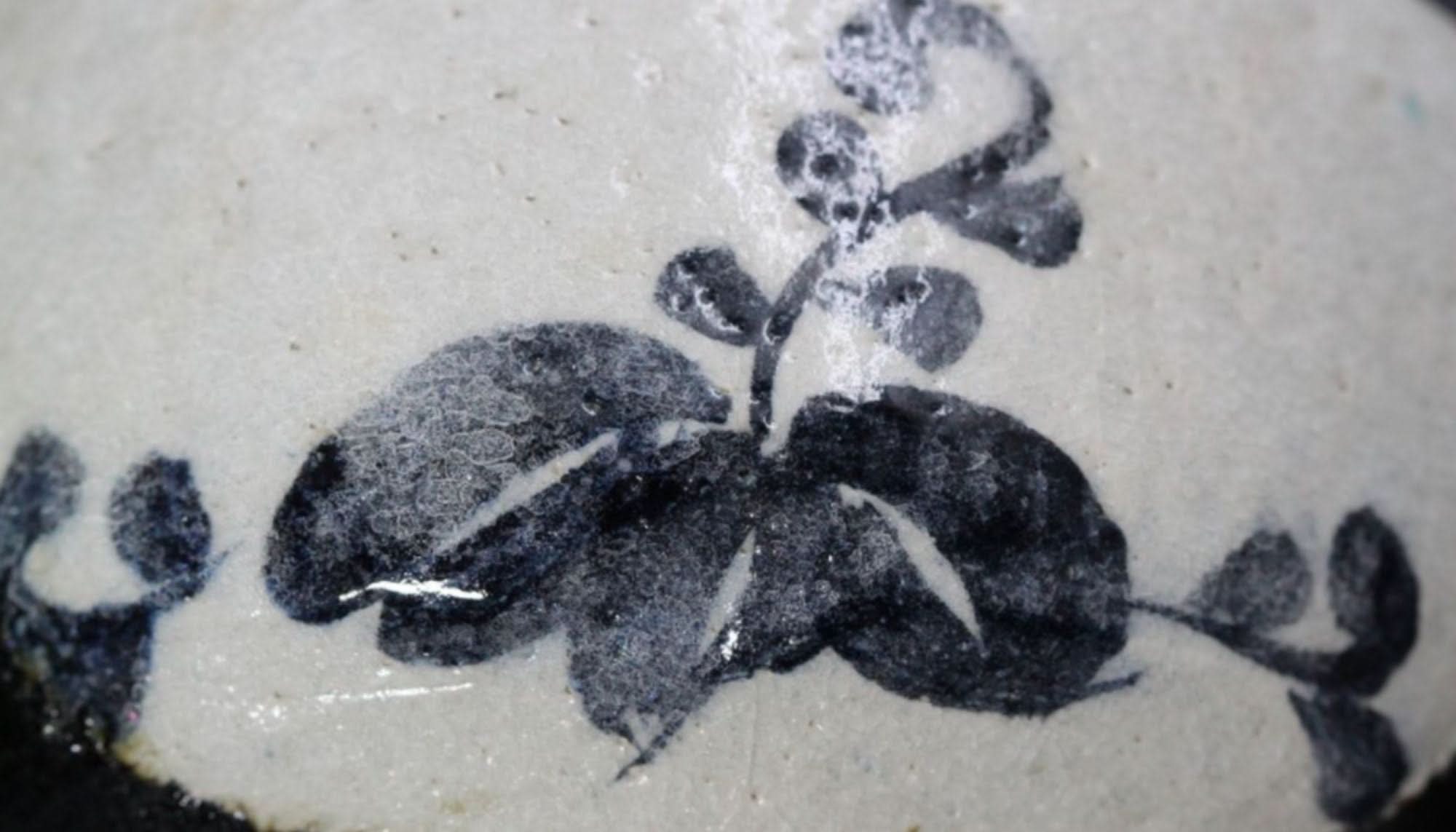 Hand-painted stoneware matcha bowl, black & white floral design. Made in Japan.