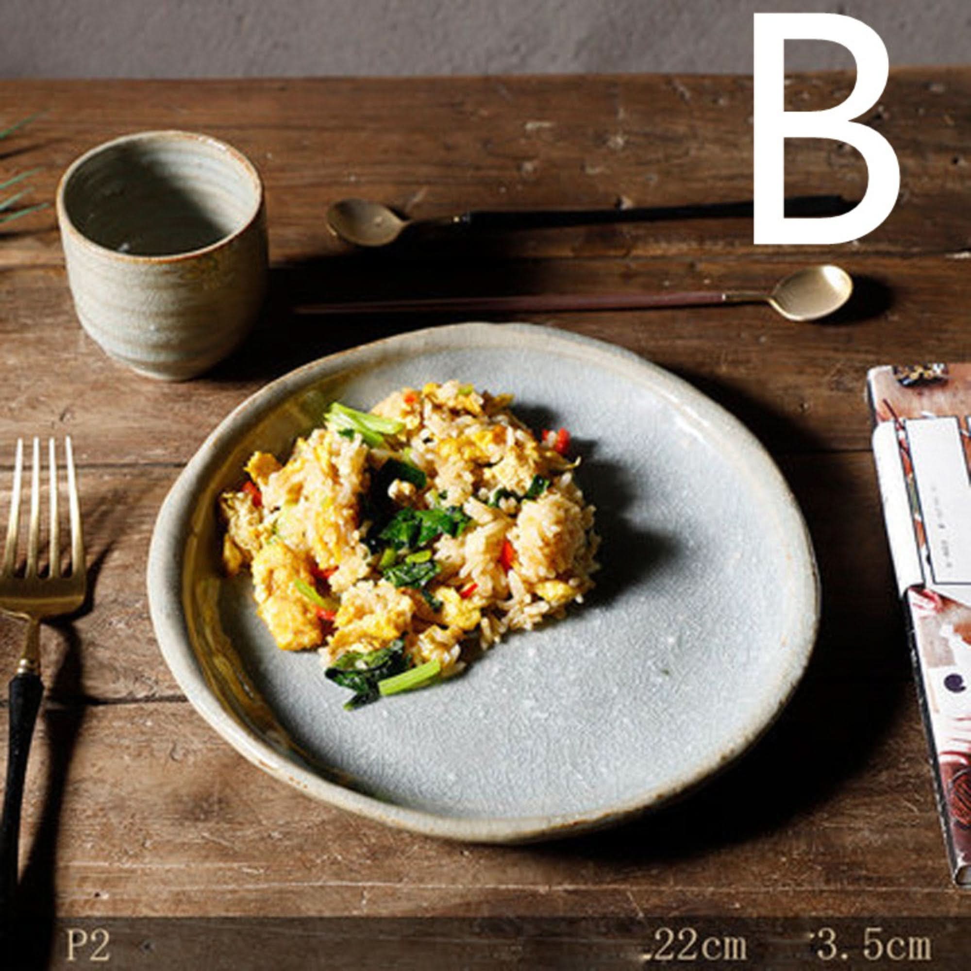 Stoneware handmade irregular ice cracked ceramic plate with food on wooden table.