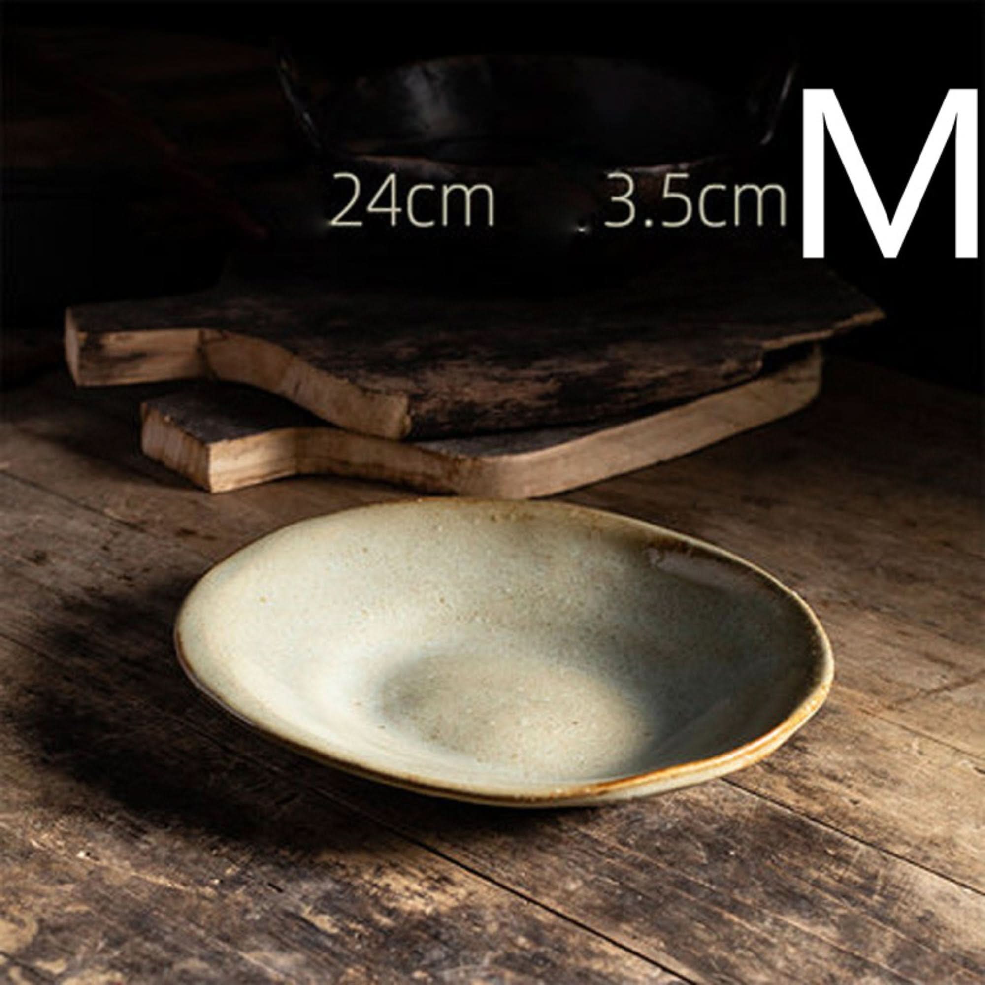 Handmade stoneware irregular ice cracked ceramic tableware, earthy tones, rustic wooden setting.