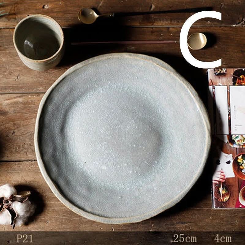 Stoneware handmade irregular ice cracked ceramic plate and bowl on wooden table.