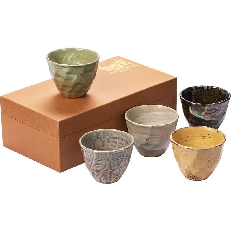 Japanese cups set: four textured ceramic cups in green, grey, beige, yellow, and black on a gift box.