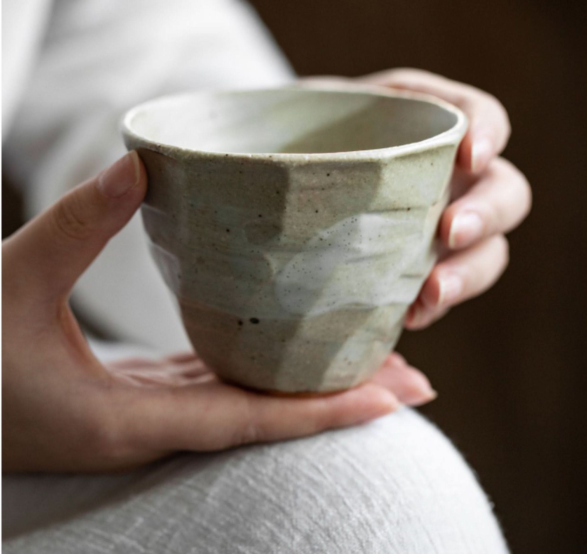 Japanese Cups Set 9.4oz: Textured ceramic cup with subtle green and white glaze held in hands.