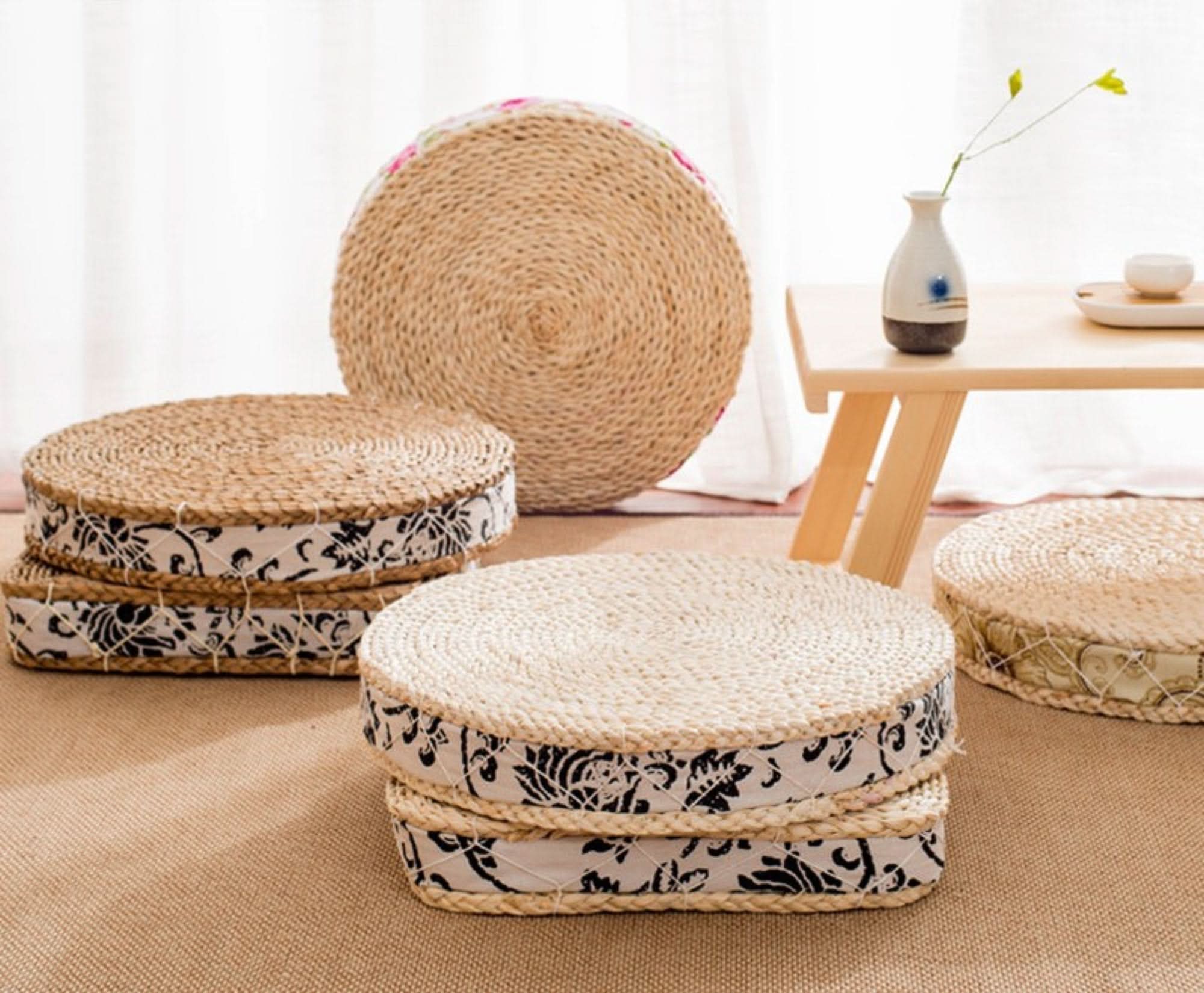 Woven straw floor poufs with black and white floral fabric decor, boho home decor.
