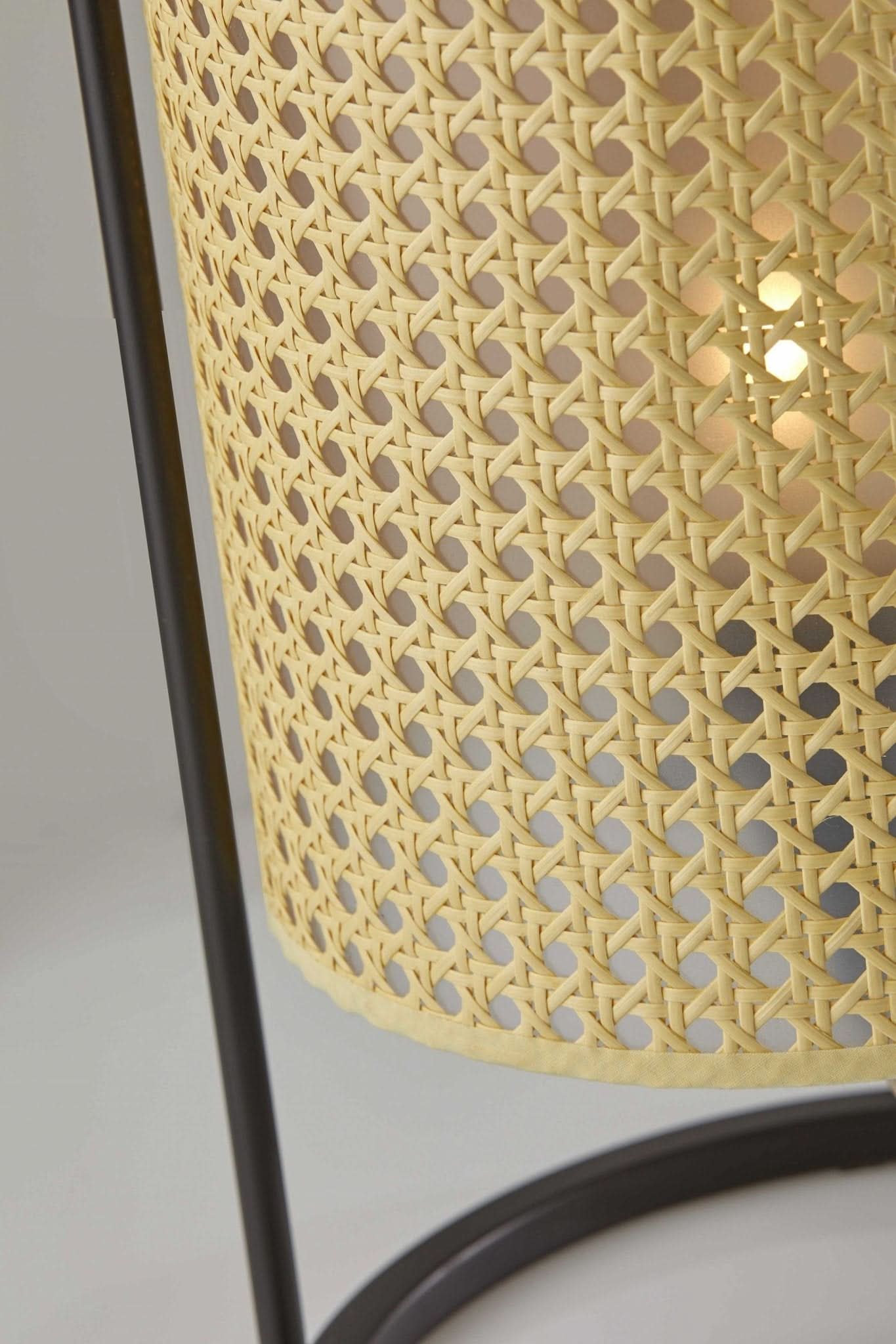 Close-up of Tall Cane Shade Table Lamp with woven natural cane shade and dark metal base.