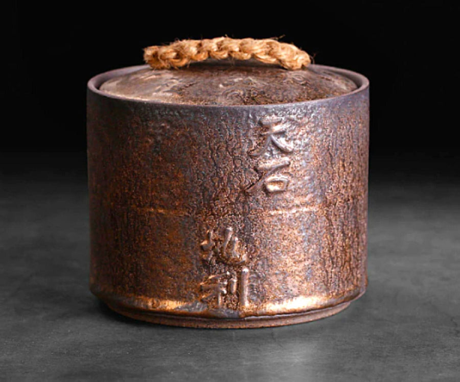 Rustic copper-toned ceramic jar, Japanese calligraphy, storage.