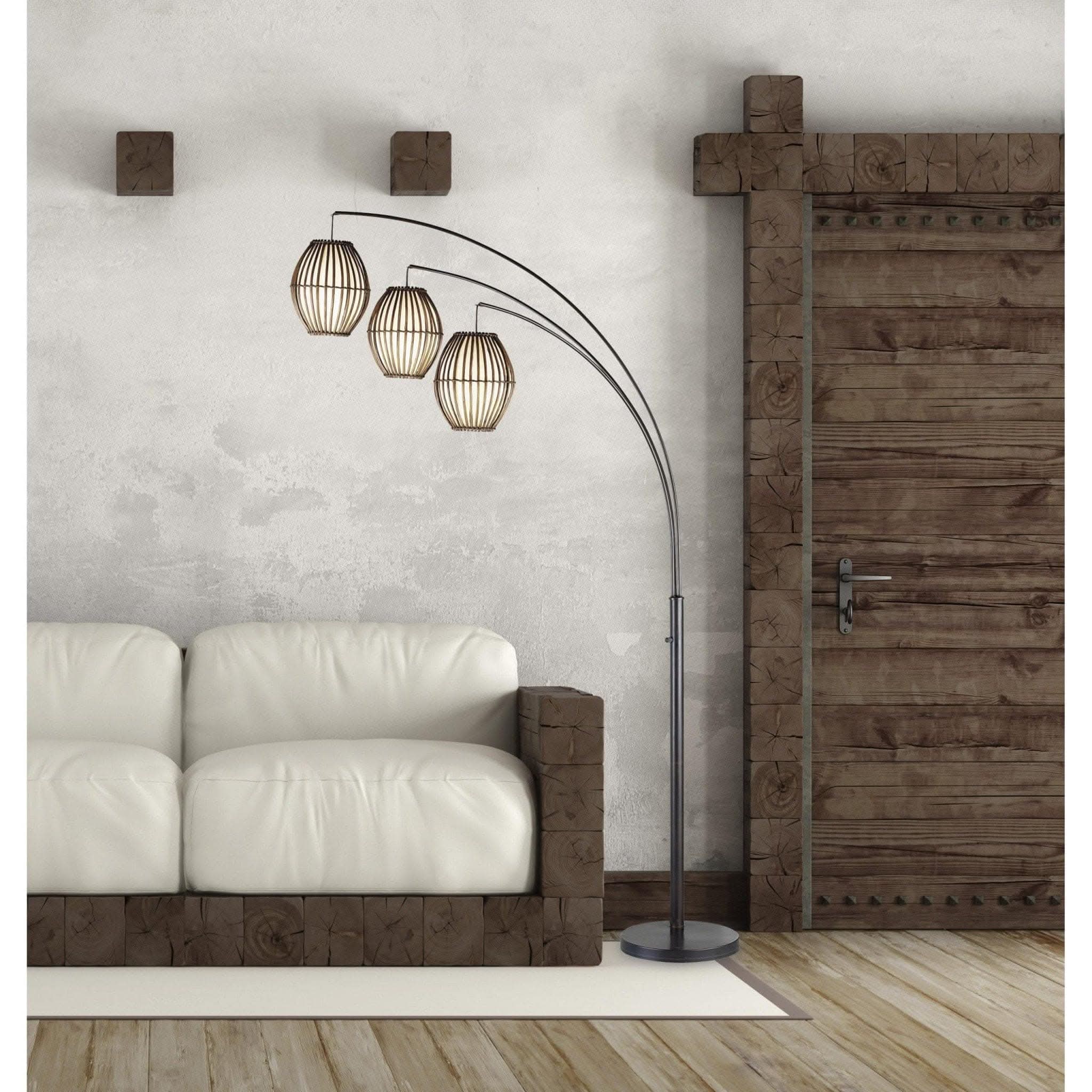 Bronze arc lamp with brown cane barrel lanterns in a living room setting.