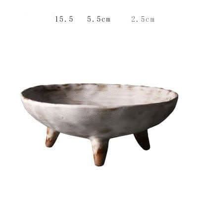 Tripod Stoneware Ceramic Irregular Fruit Bowl in rustic white and brown hues.