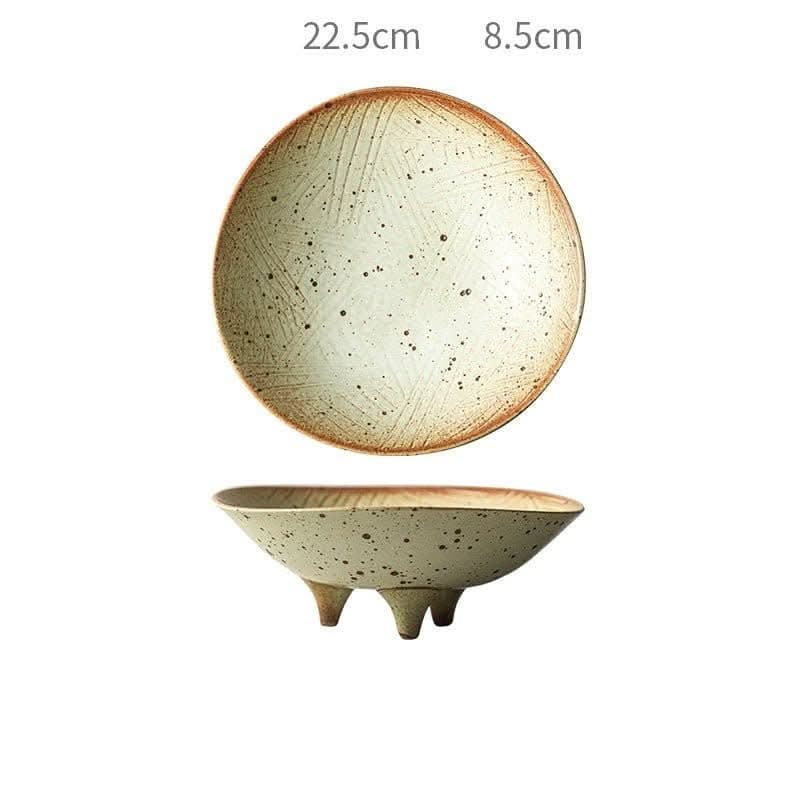 Tripod stoneware fruit plate with speckled earth tones and rustic textured rim.