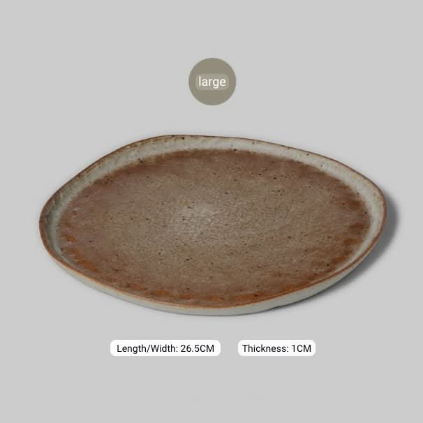 Unglazed large irregular coarse pottery flat plate in natural tones, home decor.