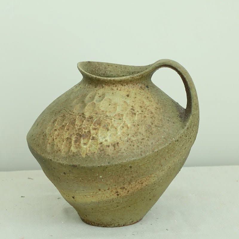 Wabi-sabi clay pot with textured, earthy green glaze and brush stroke effect. Home decor.