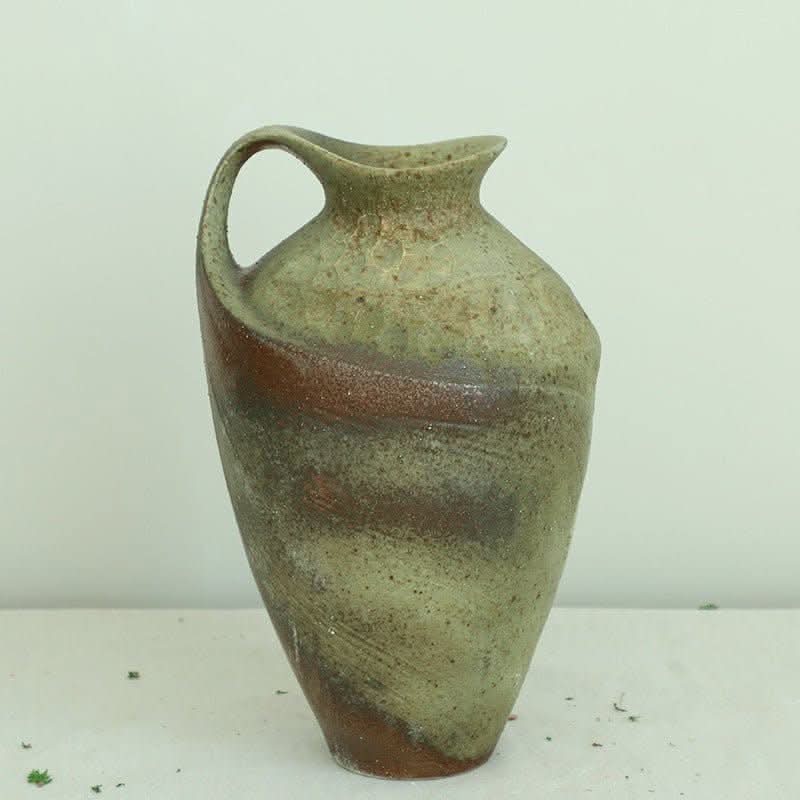 Wabi-sabi clay pot with paintbrush effect, featuring earthy green and brown tones.
