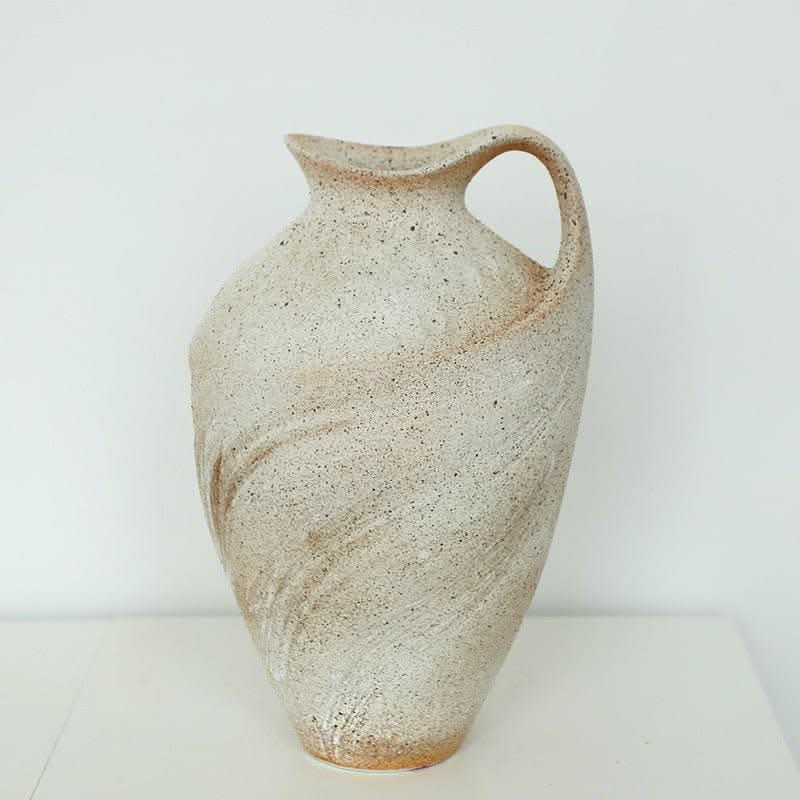 Wabi-sabi clay pot with brush stroke effect. Textured, speckled beige vase with handle on white background.
