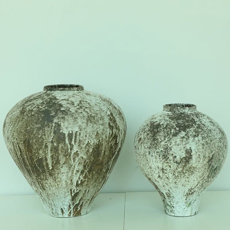 Wabi-sabi distressed beige and brown ceramic vases with textured finish. Home decor.