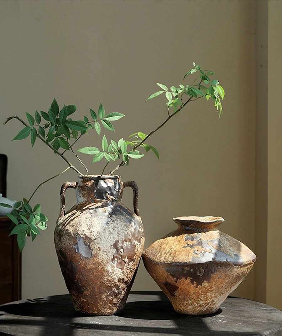 Wabi-Sabi Distressed Rustic Vases: Two distressed ceramic vases with natural green branches.