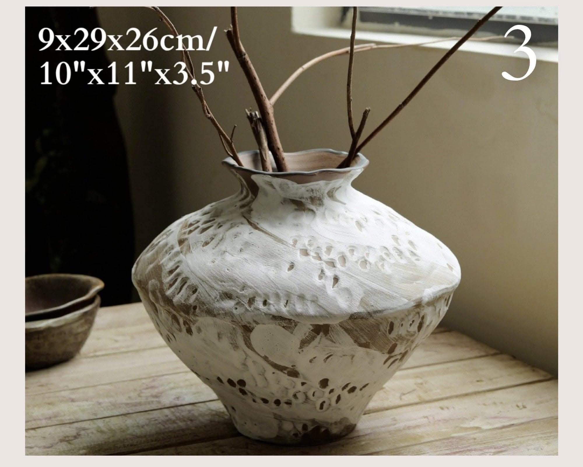 Wabi-Sabi Distressed Rustic Vase with branches, textured ceramic in cream and brown on wood.